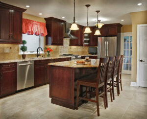Pella Designer Series wood windows in kitchen, featuring white interior frames, natural light, and energy efficient glass above sink and cabinetry